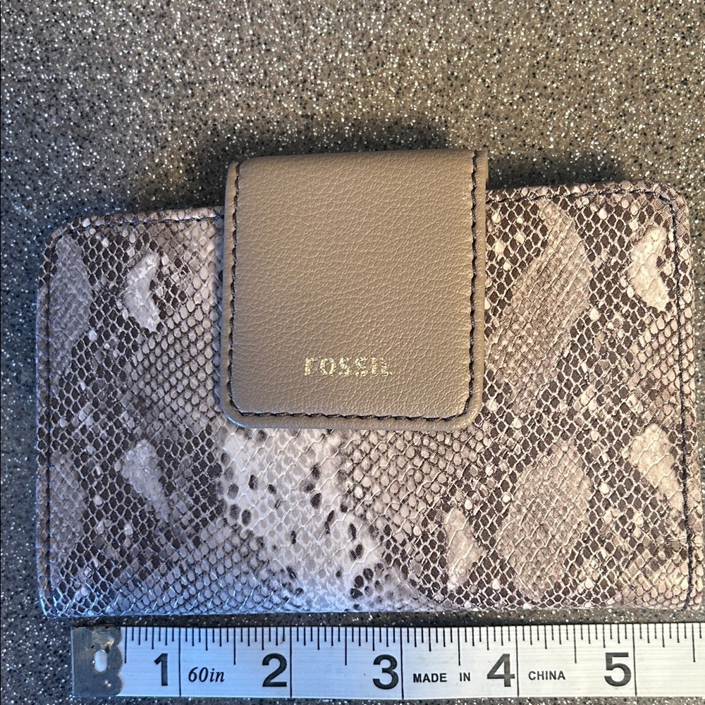 Pretty. Faux snakeskin. Snap closure. Outside zippered compartment.